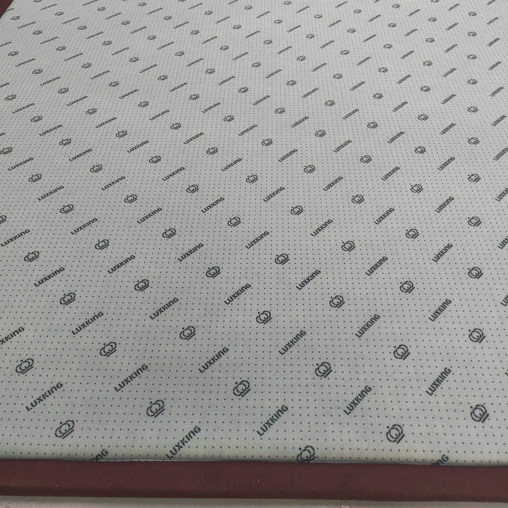 Sheet of material with a grid pattern and brand logo on a flat surface