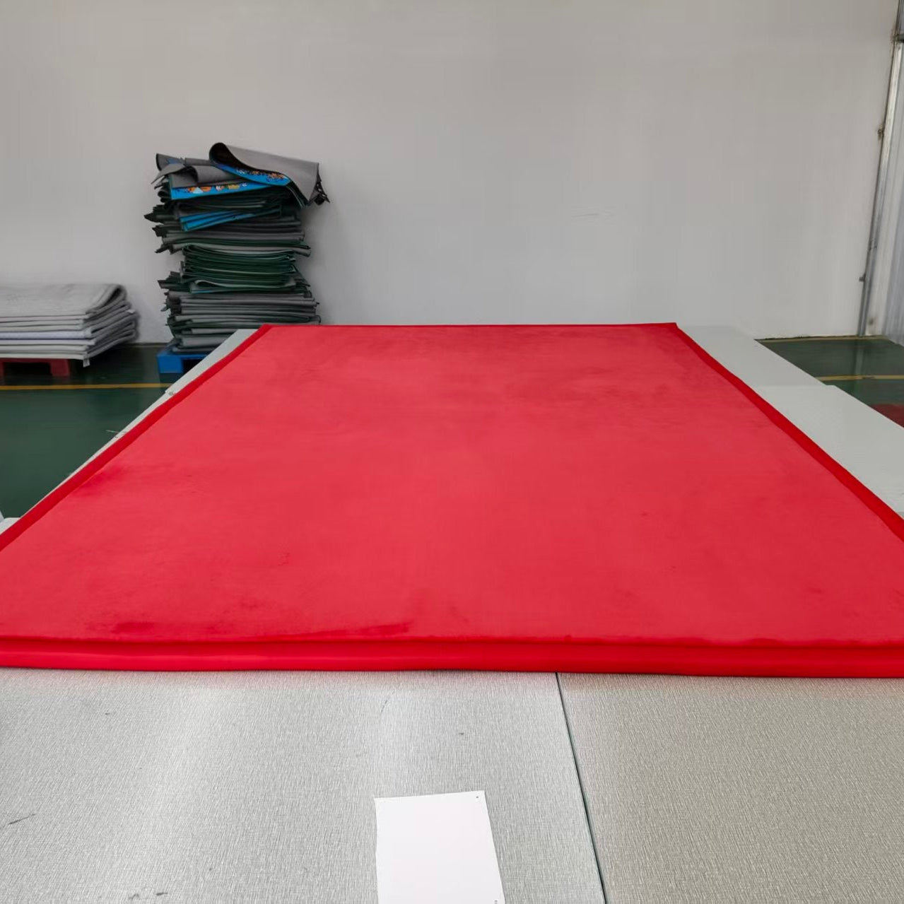 Red mat on a table with stacks of papers in the background