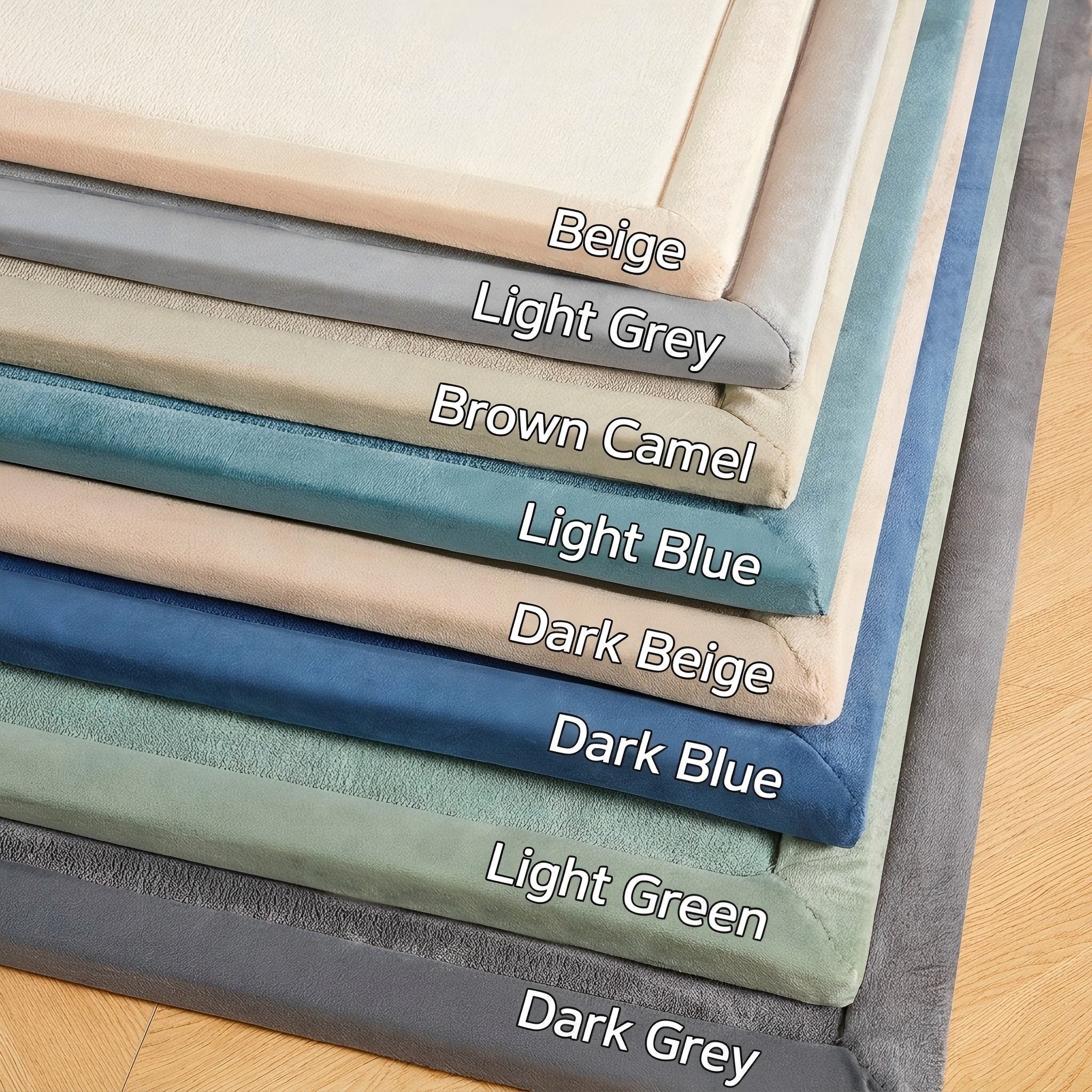Stack of fabric swatches in various colors with labels on a wooden surface