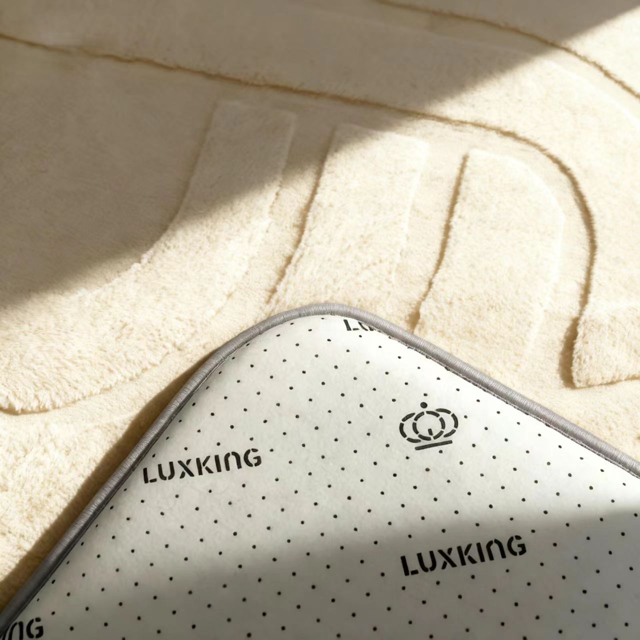 Luxking branded mattress topper with brand logo on a textured beige background