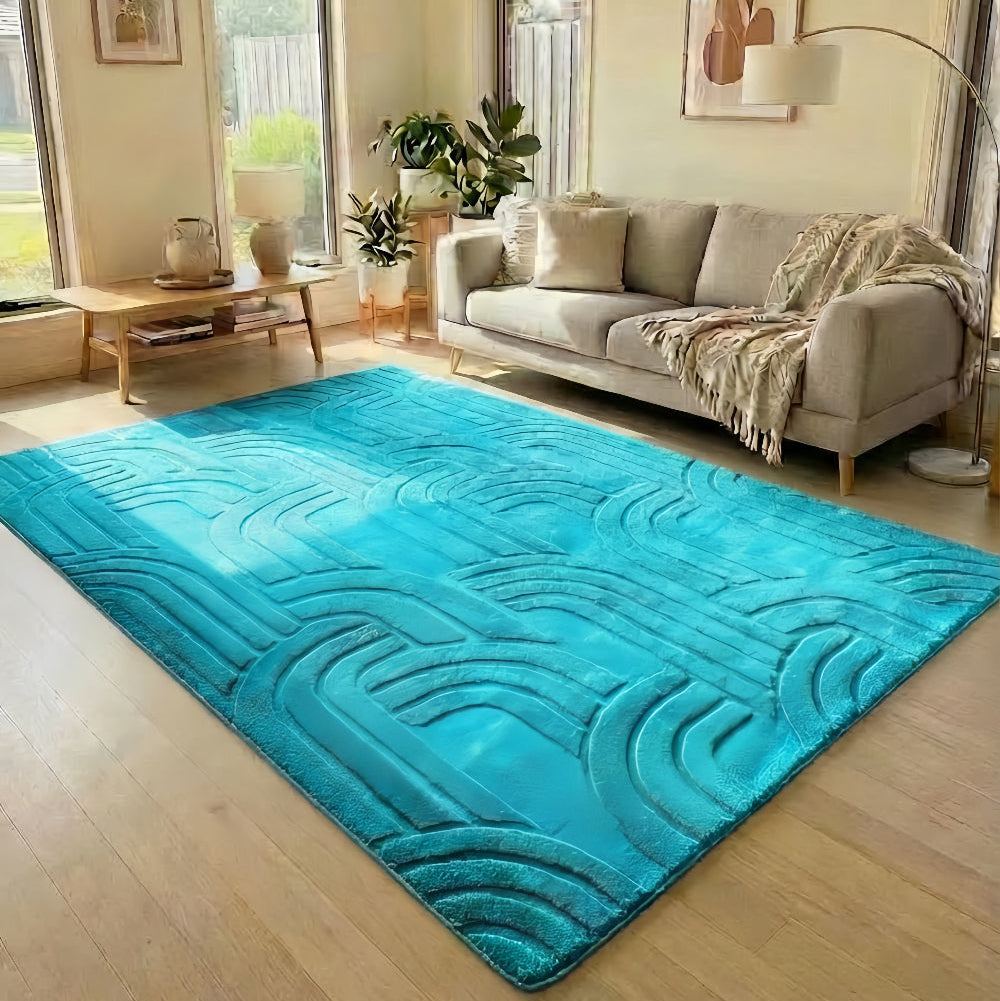 Living room with a blue textured rug, beige sofa, and large windows.
