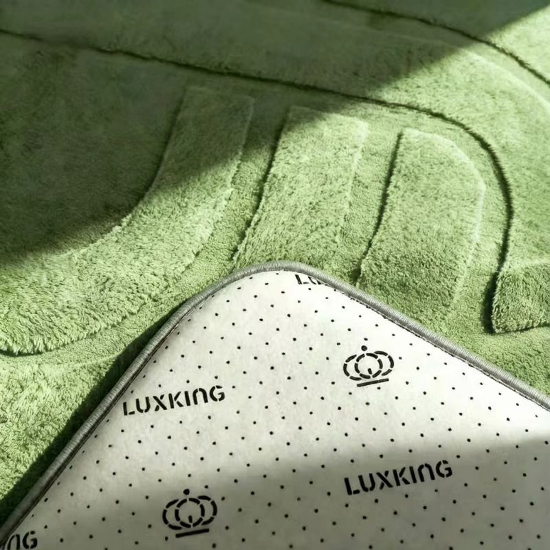 Close-up of a green bath mat with 'Luxking' branding.