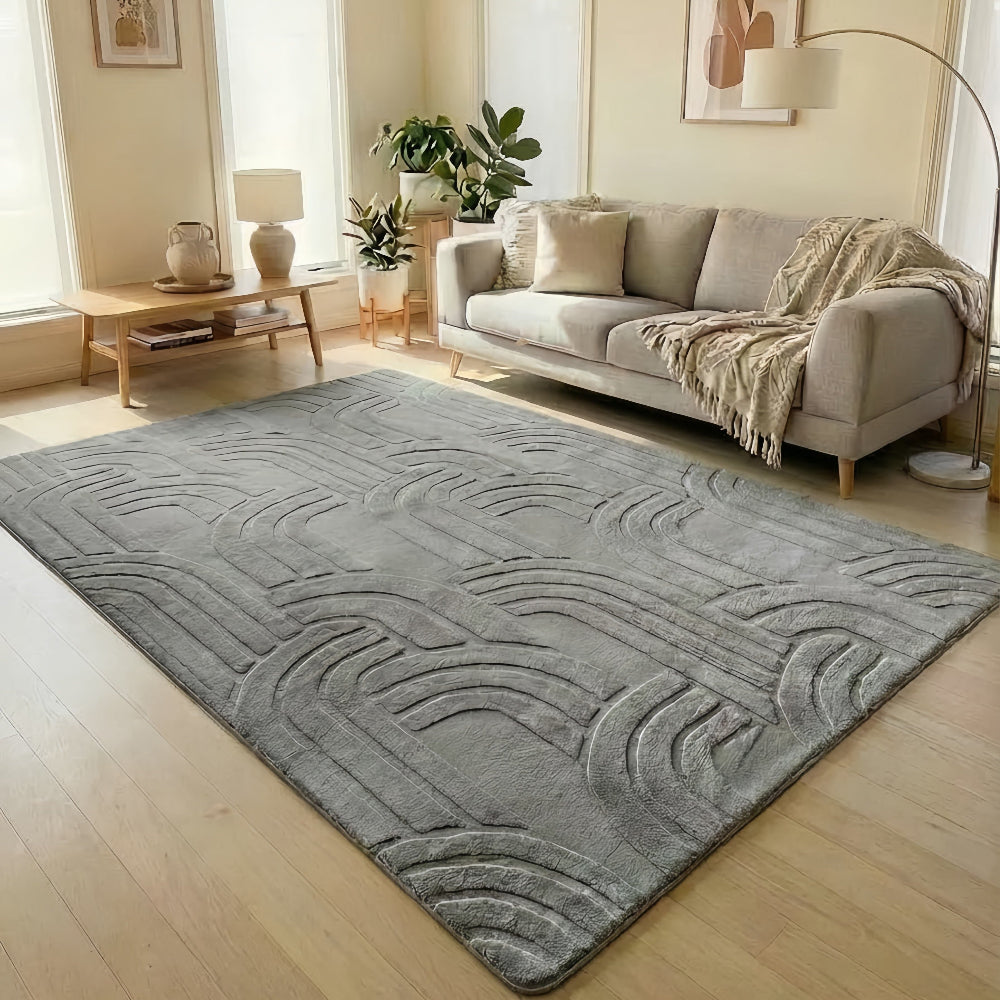 Living room with a gray textured rug, beige sofa, and decorative elements.
