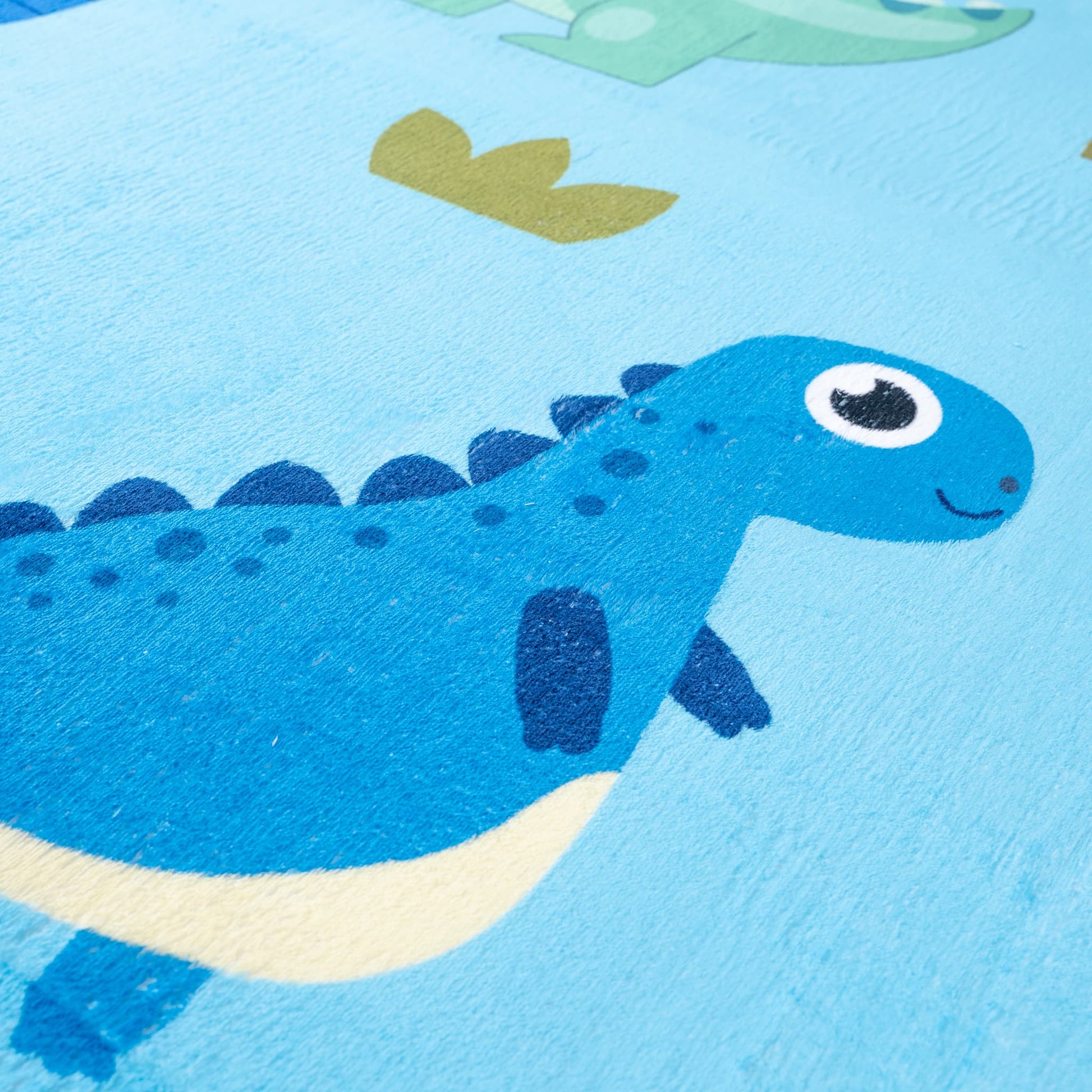 Close-up of a blue dinosaur toy on a blue background