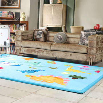 Living room with a brown sofa and a colorful LuxKing dinosaur Cloud Mat on the floor.