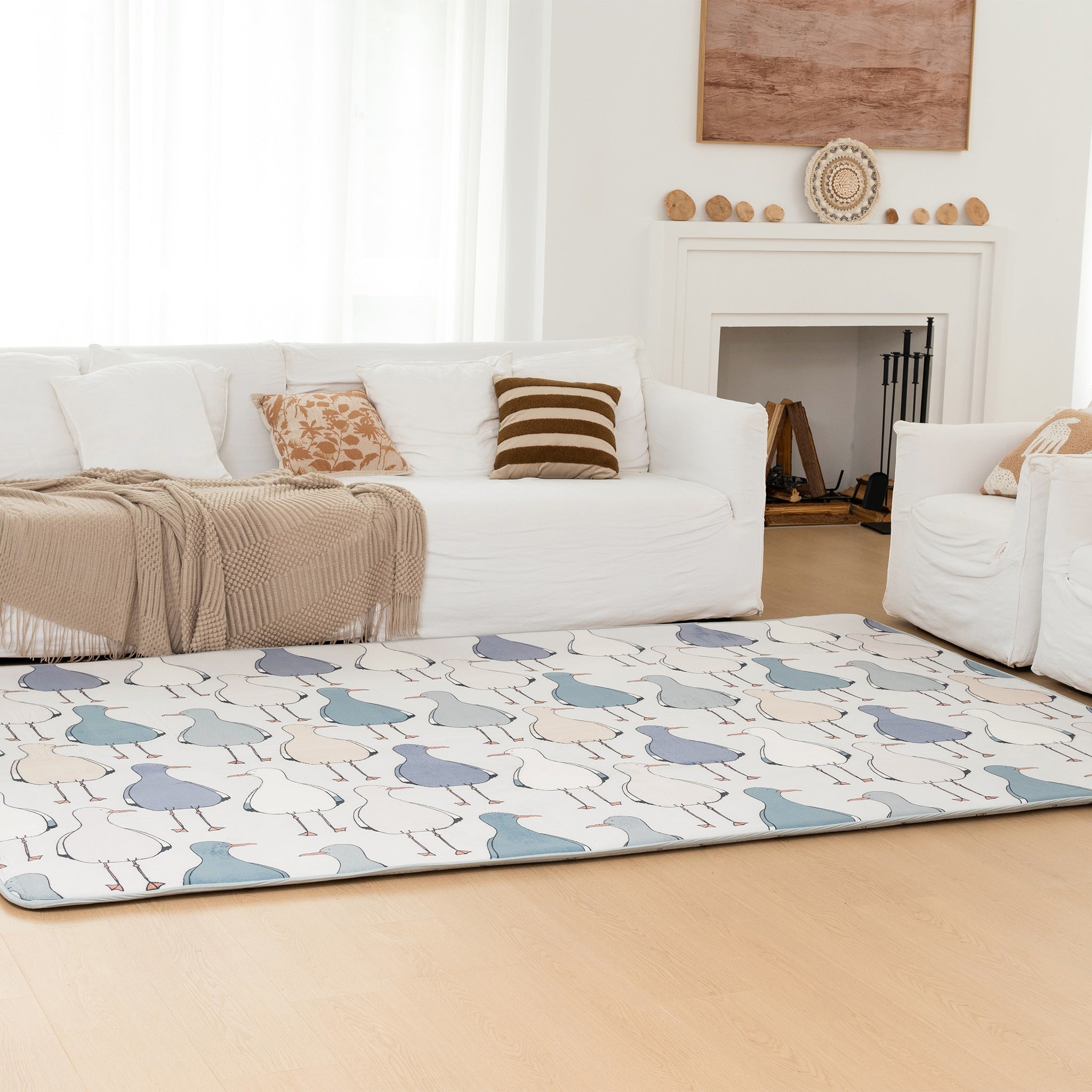 Living room with a white sofa, patterned rug, and decorative items.