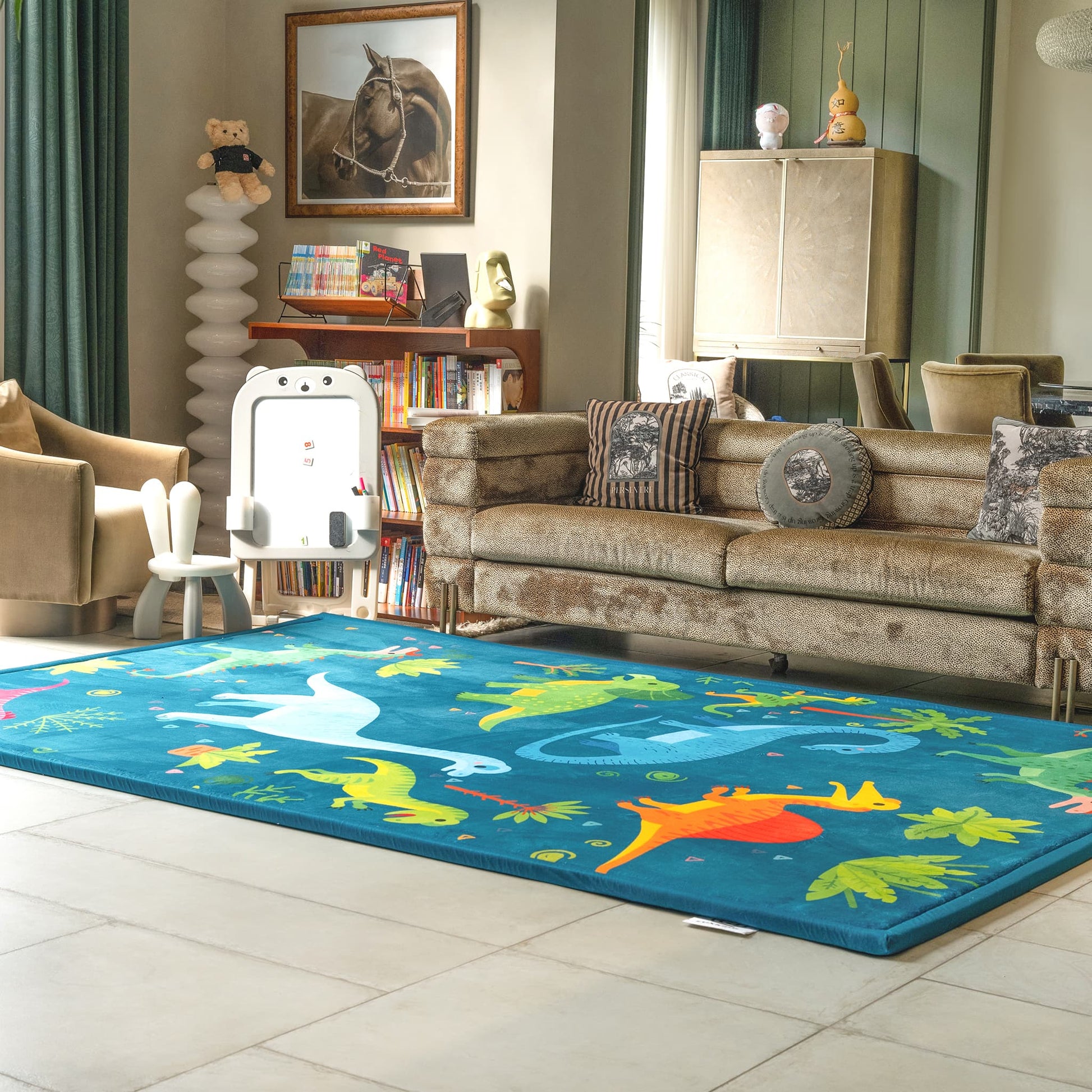 Living room with a LuxKing Cloud Mat featuring Dino Forest setting with Dinos in it and a couch, and children's furniture around the cloud mat.