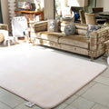 Beige rug on a tiled floor with a beige sofa in the background