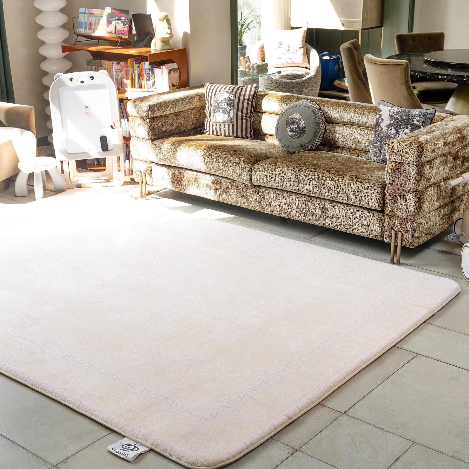Beige rug on a tiled floor with a beige sofa in the background