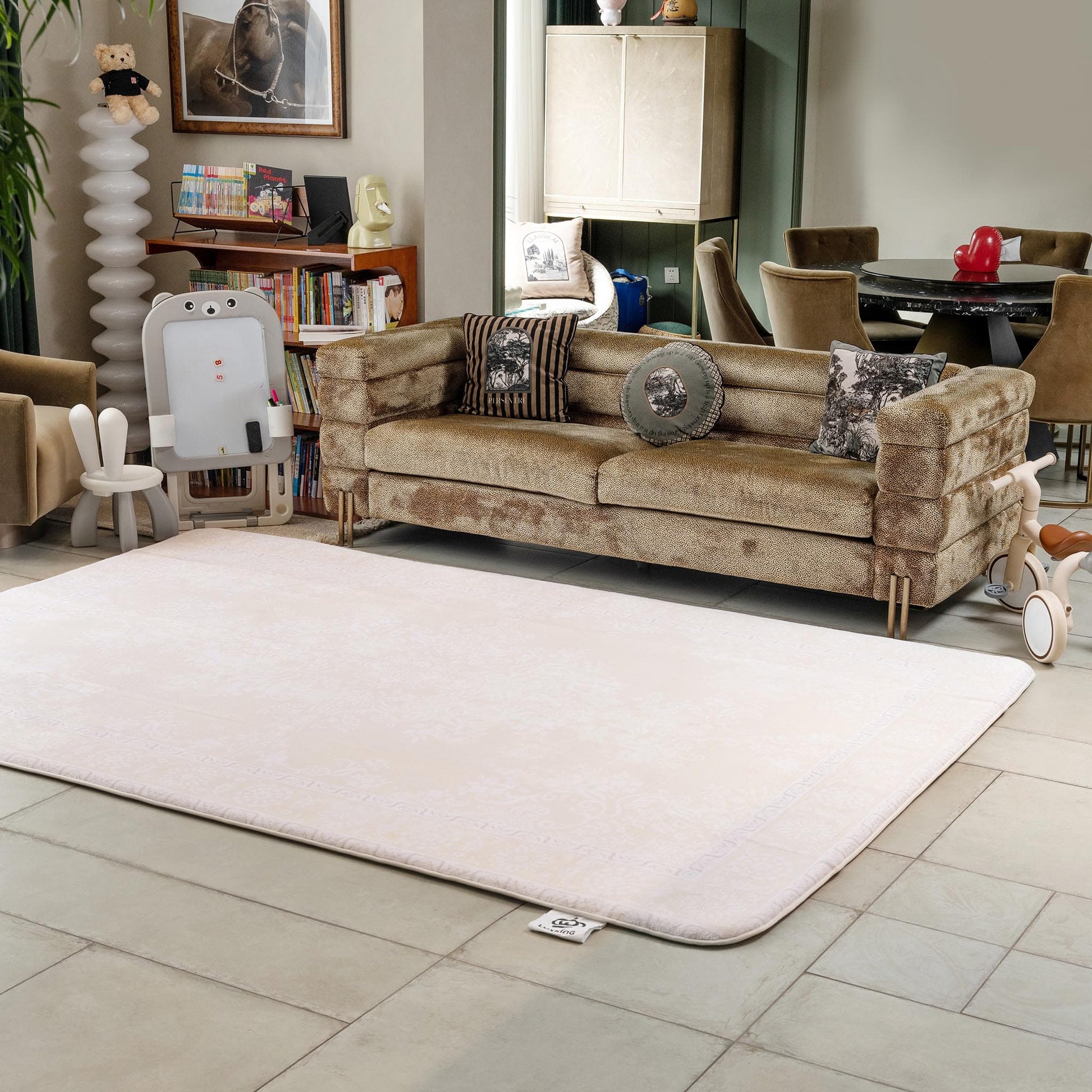 Brown sofa with decorative pillows on a beige rug in a living room setting.