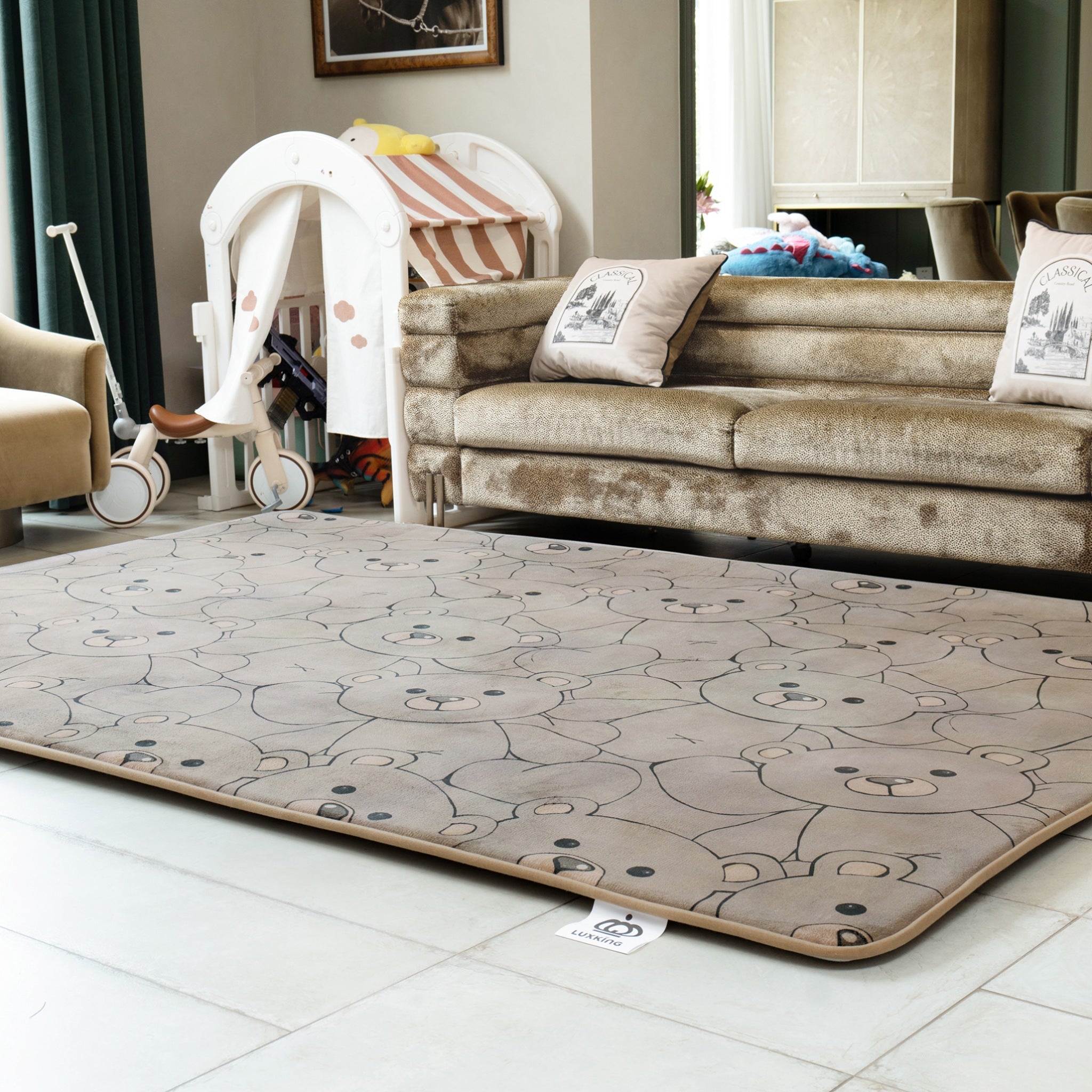 Children's play mat with teddy bear design on a tiled floor in a living room.