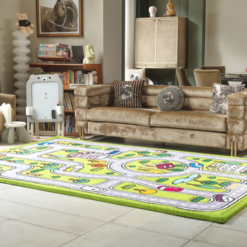 Living room with a colorful play mat on the floor, sofa, and books.