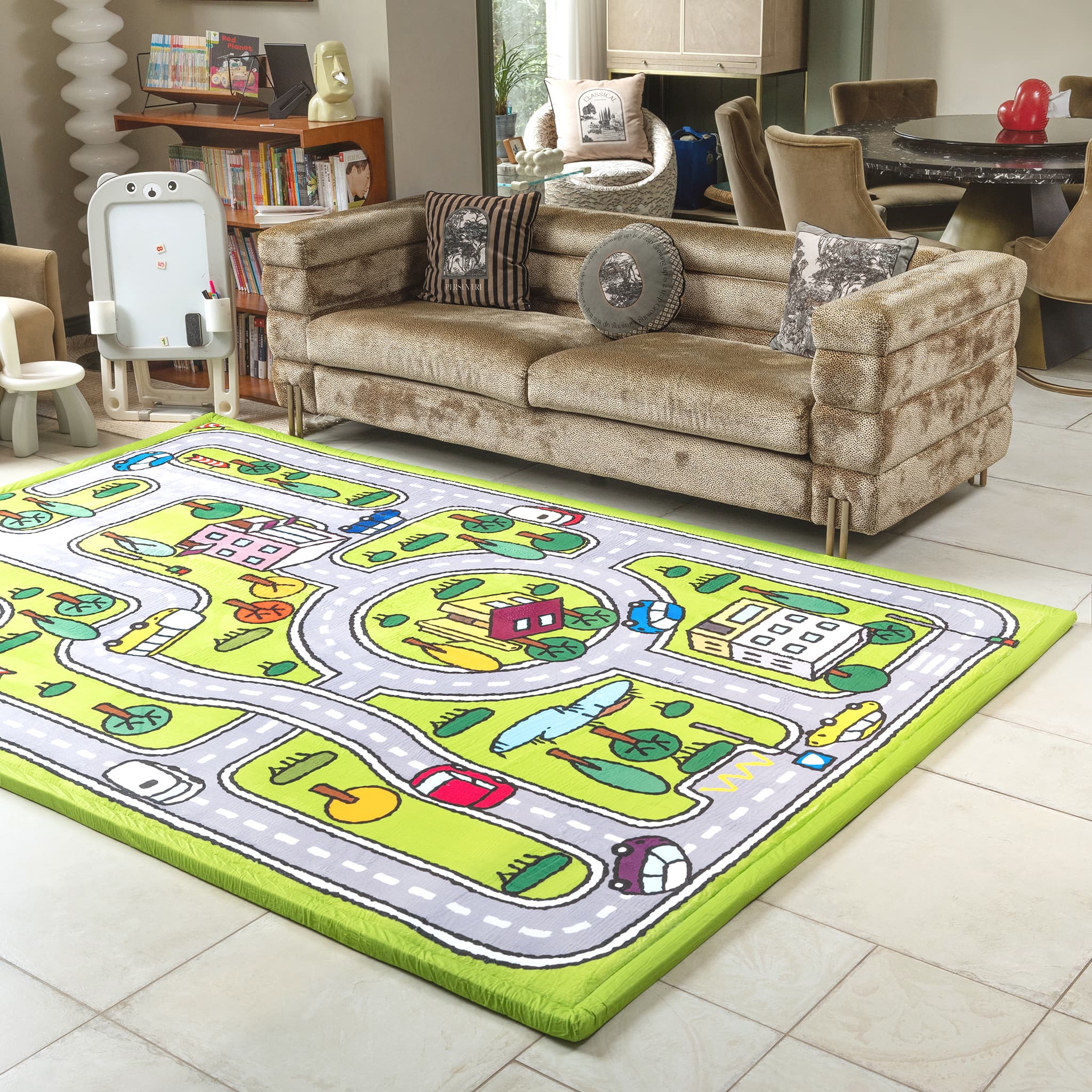 Colorful children's play mat on a tiled floor with a couch and books in the background