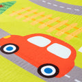 Children's play mat with a red car and road markings on a green background
