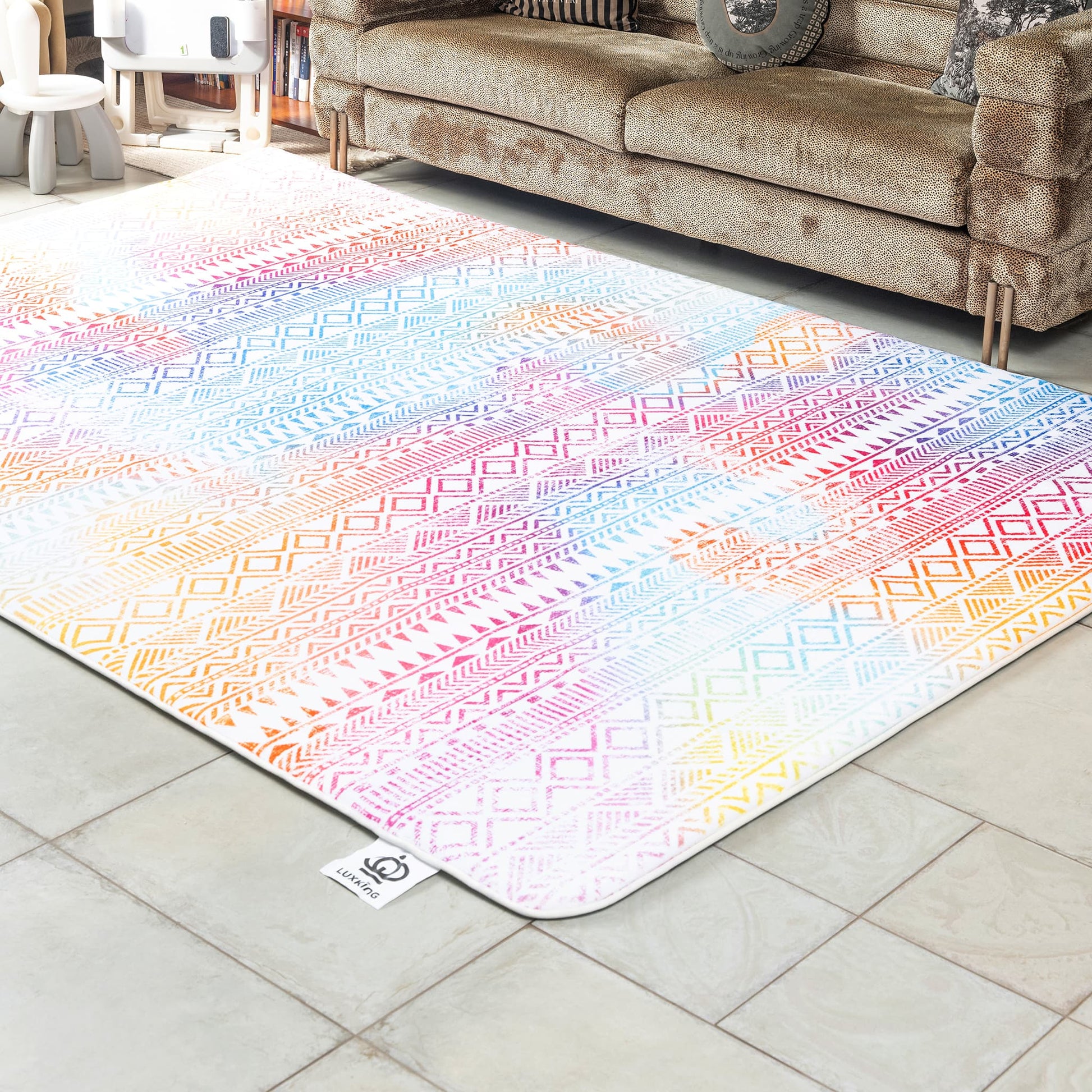 Multicolored patterned rug on a tiled floor with a beige sofa in the background