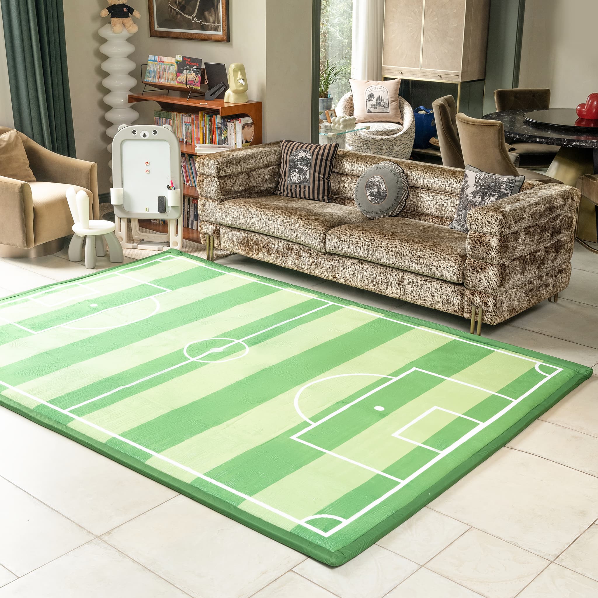 Living room with a green sports-themed rug, beige sofa, and various decor items.