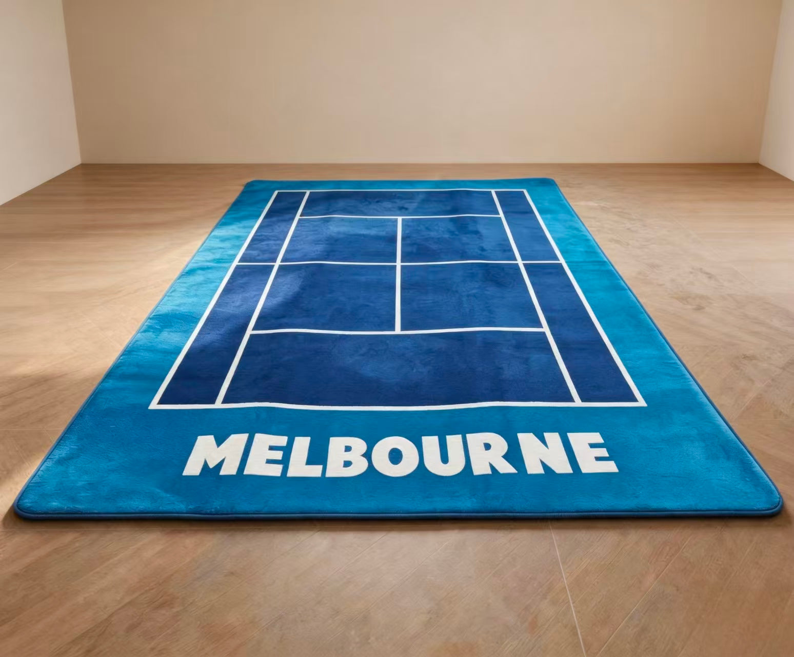 Blue rug with tennis court design and 'Melbourne' text on a wooden floor.