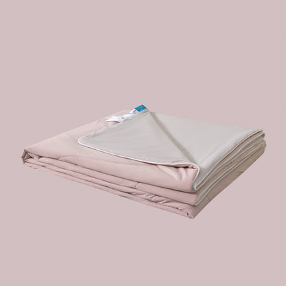Folded pink blanket with a white label on a beige background