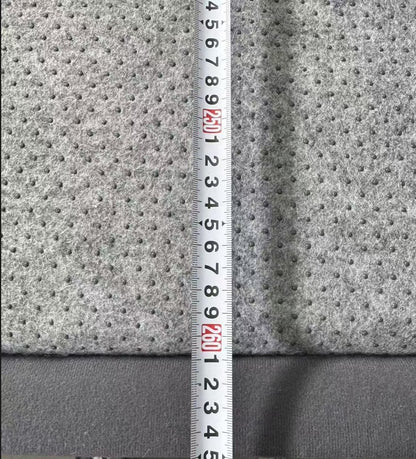 Gray textured fabric with a ruler for scale