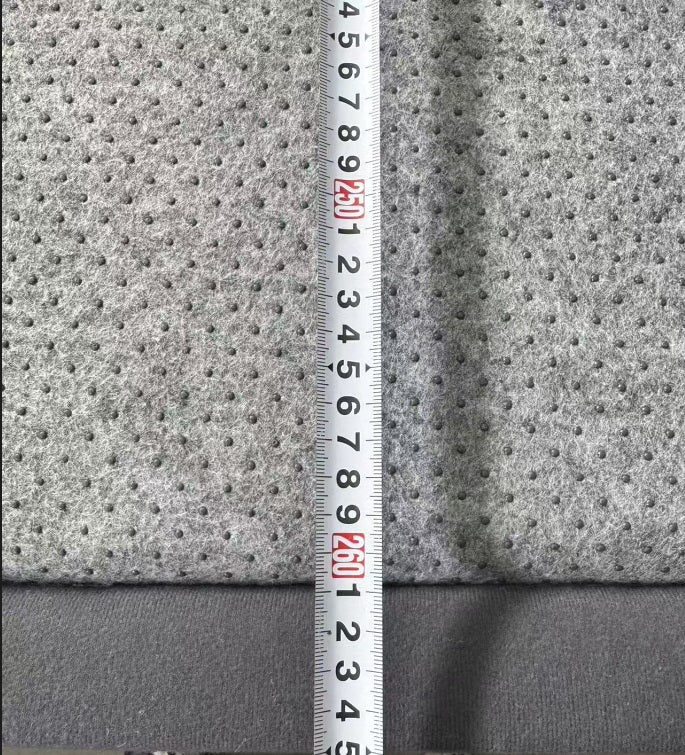 Gray textured fabric with a ruler for scale