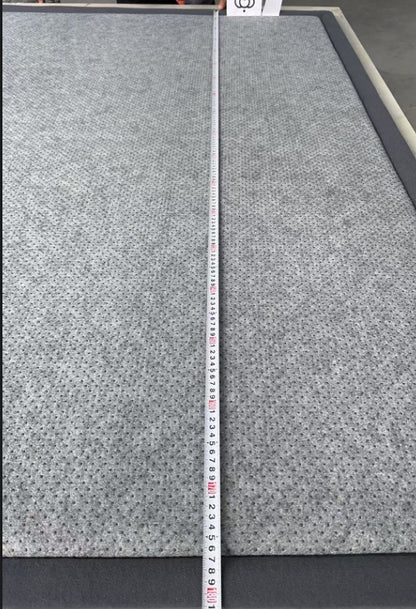 Gray textured material with a measuring tape for scale on a gray background
