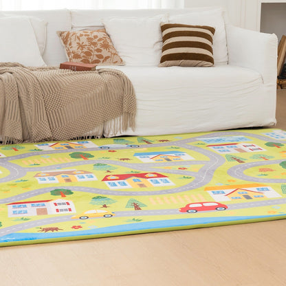 Living room with a colorful rug featuring roads and houses, a white sofa with pillows, and a fireplace.
