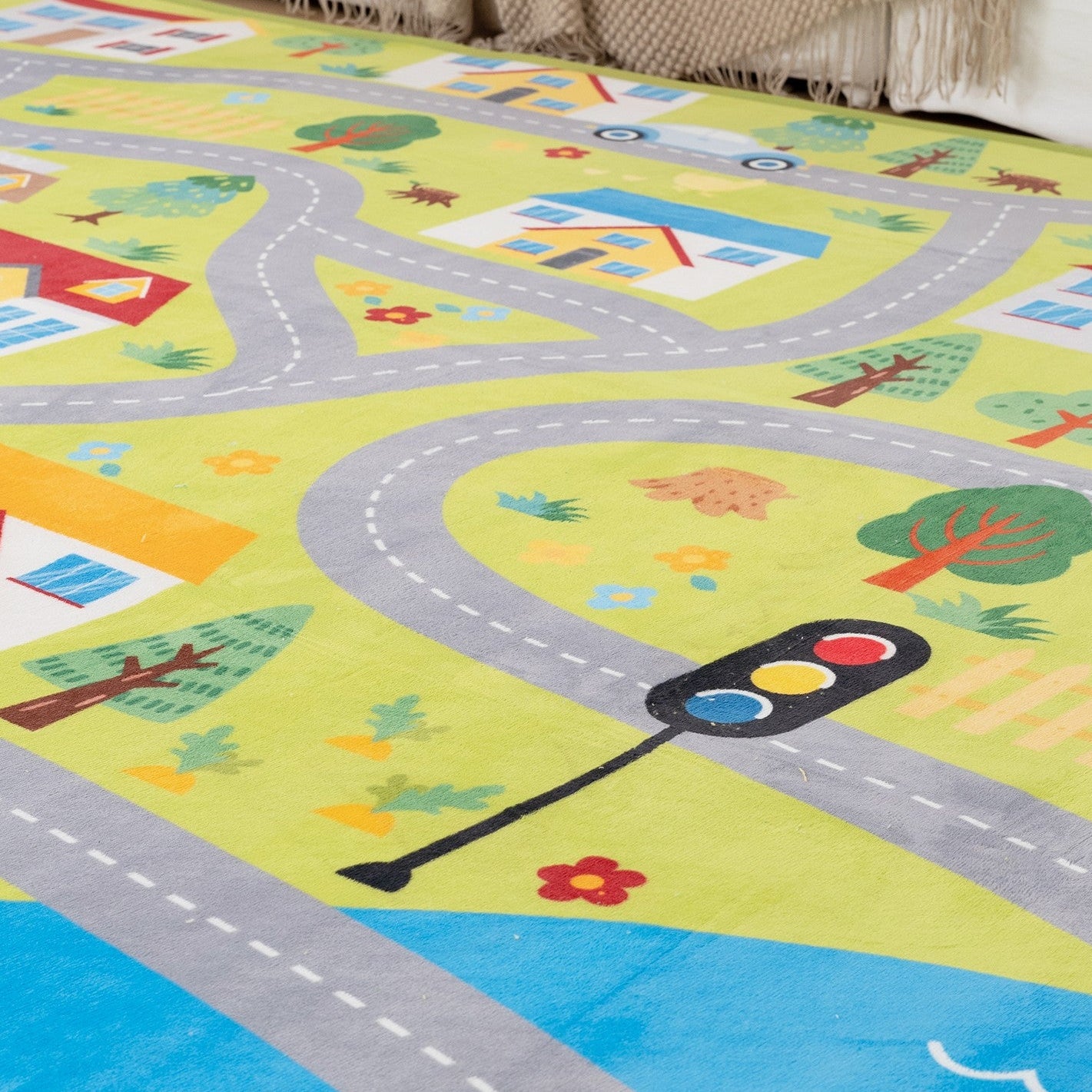Colorful children's play mat with road design in a living room setting.