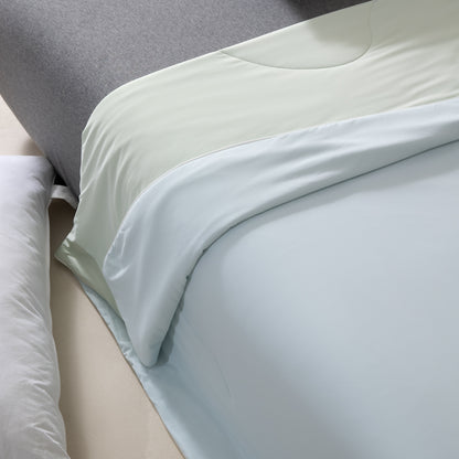 Light blue fitted sheet on a bed with pillows