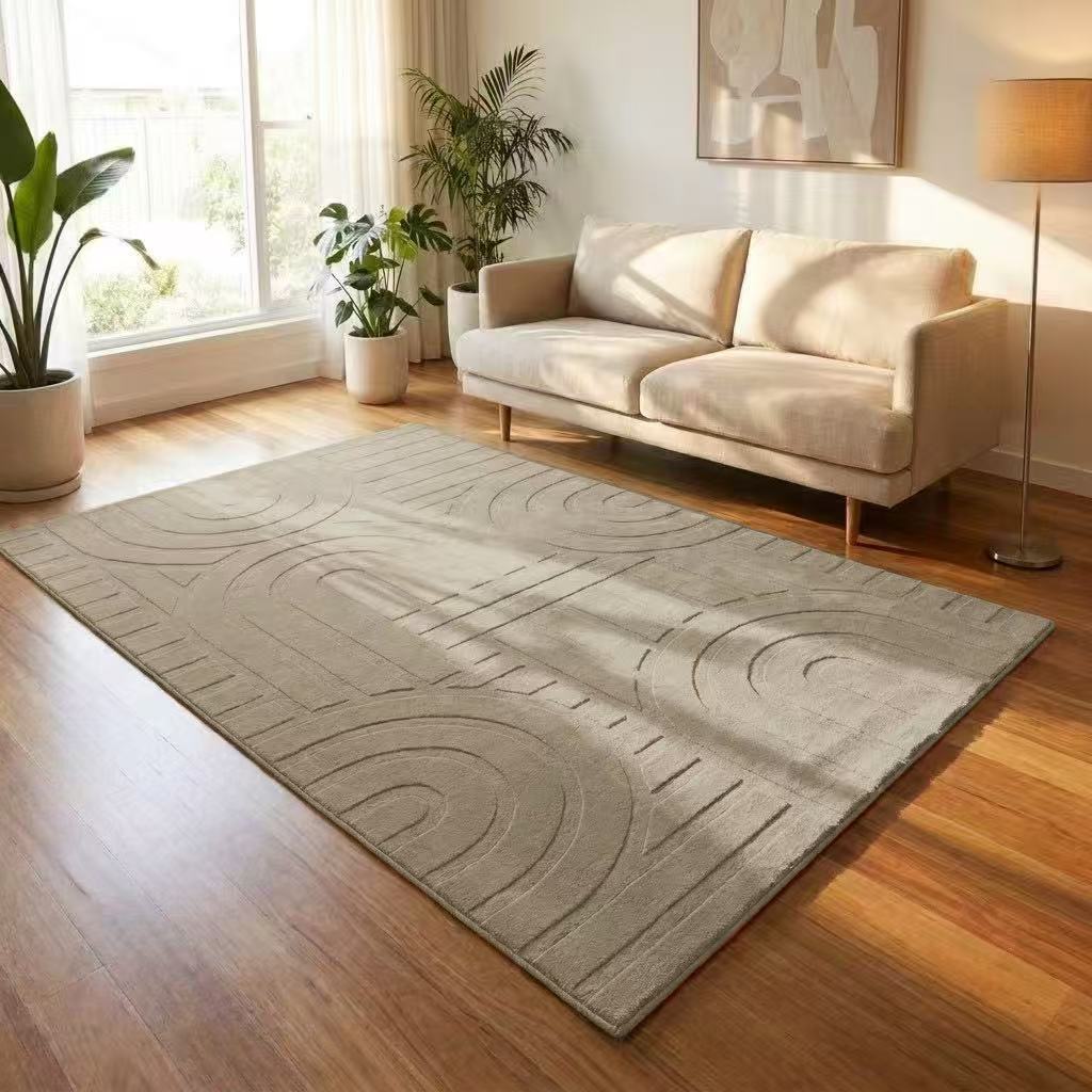 Living room with a gray textured rug, white sofa, and plants.
