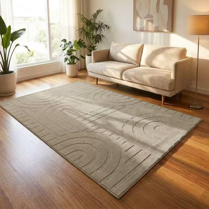 Living room with a gray textured rug, white sofa, and plants.