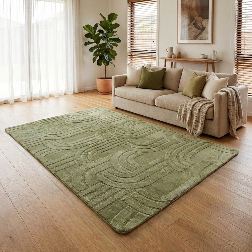 Living room with a green rug, beige sofa, and decorative elements.