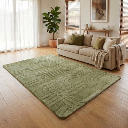 Living room with a green rug, beige sofa, and decorative elements.
