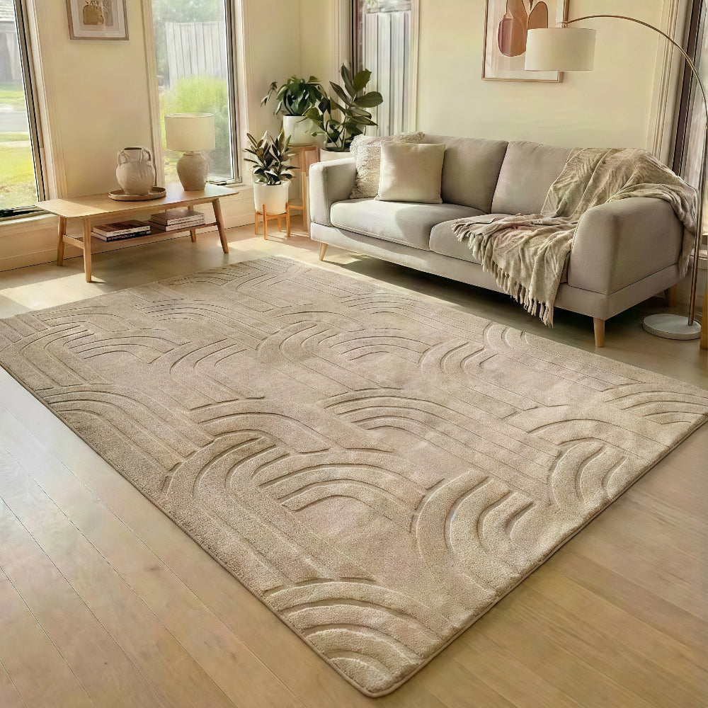 Living room with a beige rug, sofa, and decor elements.