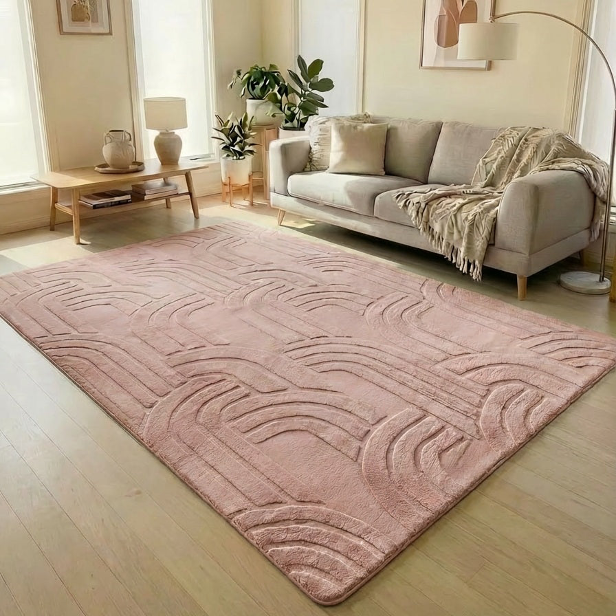 Living room with a pink textured rug, beige sofa, and decorative items.