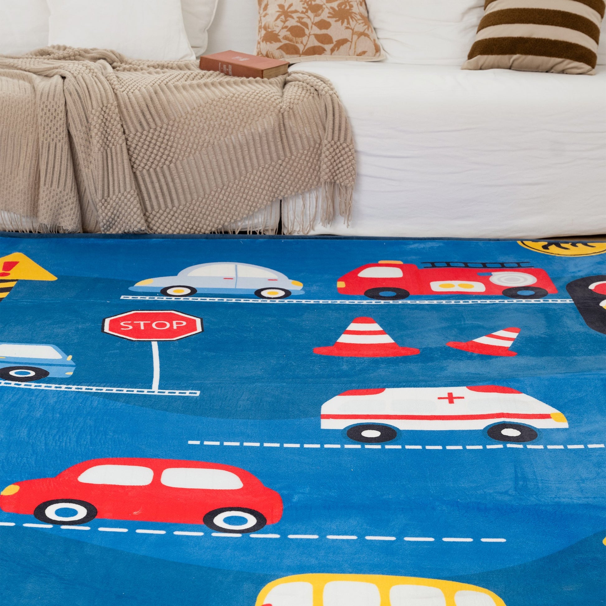 Children's play mat with colorful cars and traffic signs on a blue background