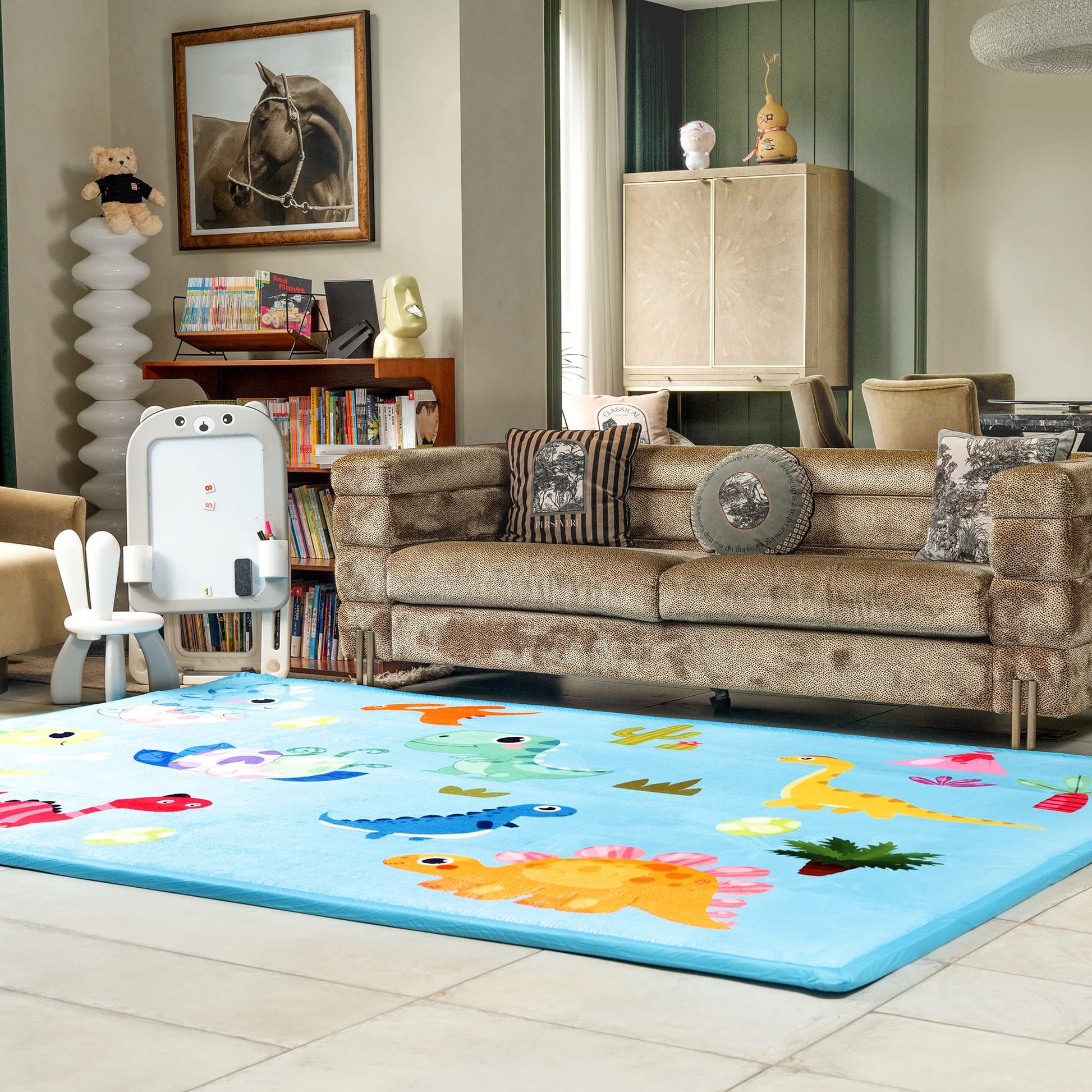 Children's room with a colorful rug featuring animal designs, a sofa, and toys.