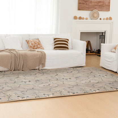 Living room with a white sofa, patterned rug, and decorative items.
