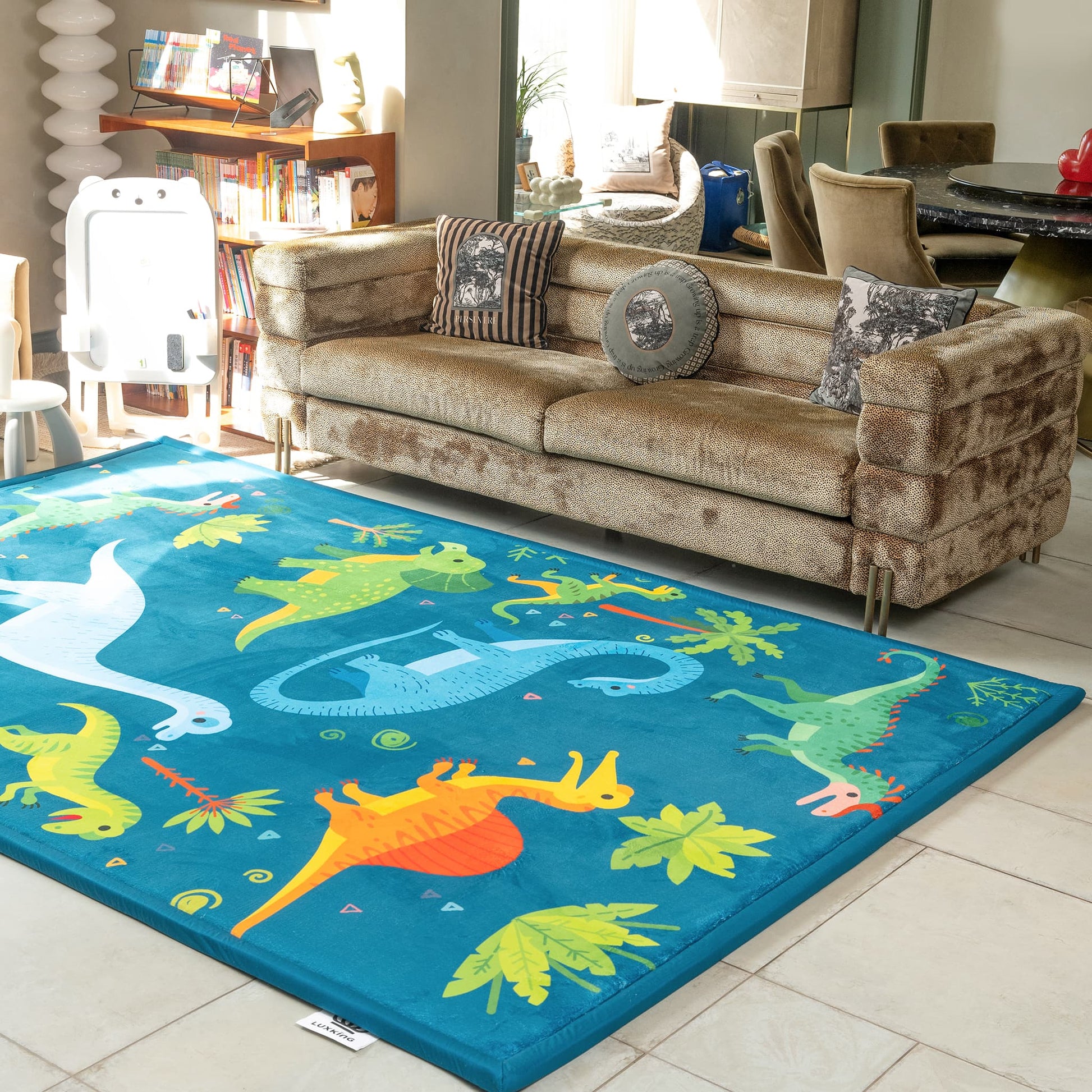 Children's dinosaur rug in a living room with a brown sofa.