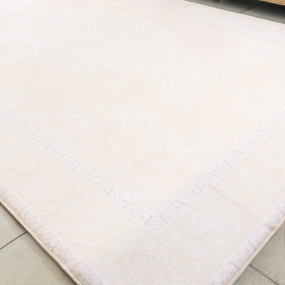 Beige bath mat on a tiled floor