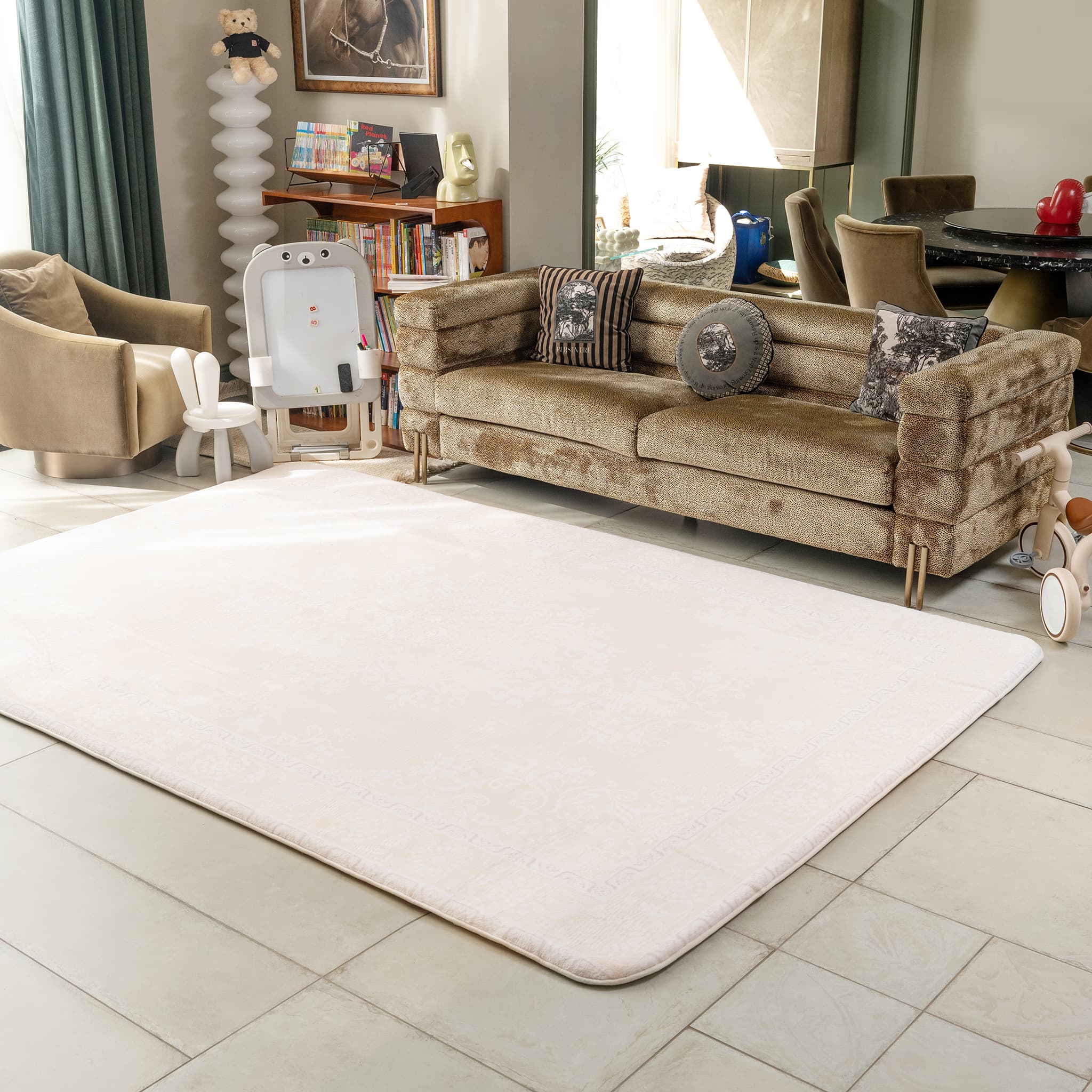 Living room with a beige sofa, rug, and decorative items.