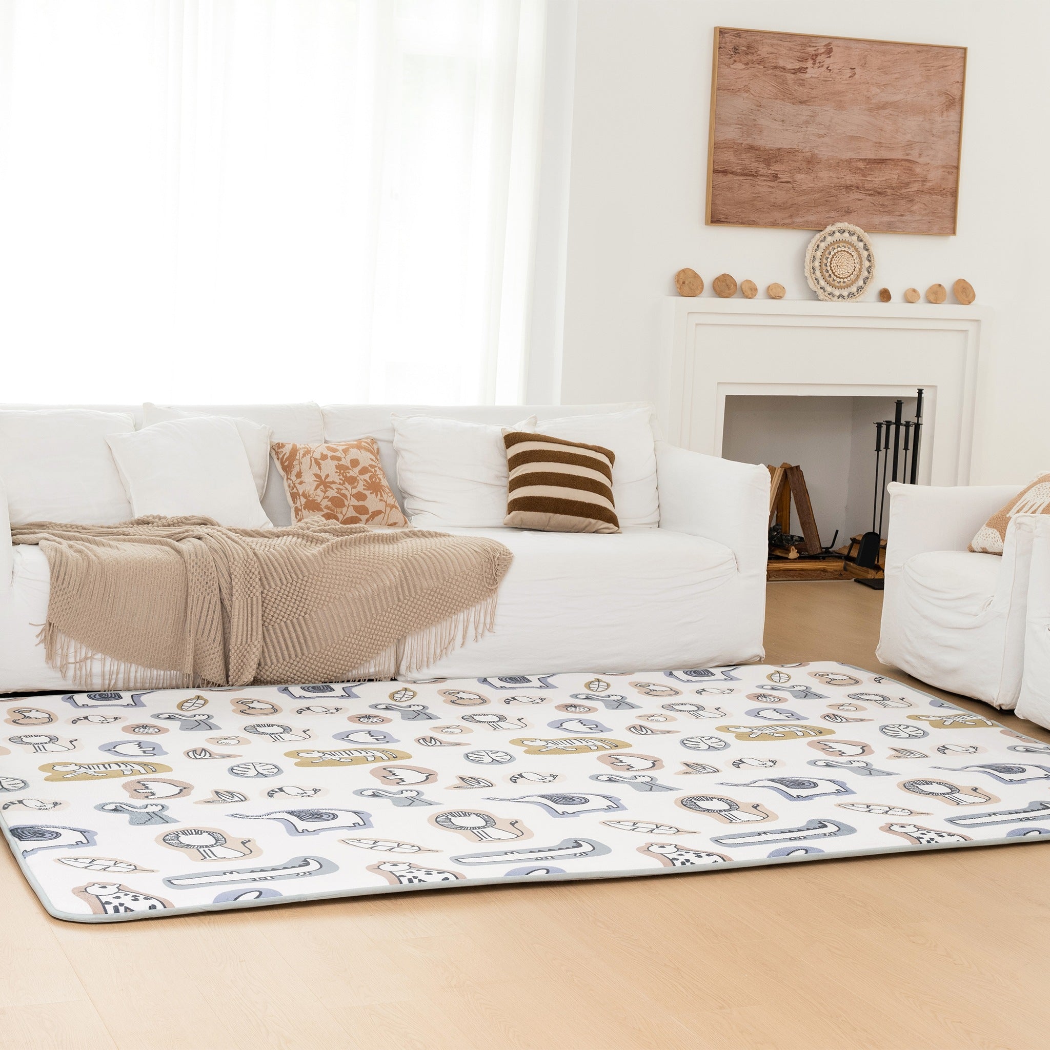 Living room with a white sofa, striped rug, and decorative items.