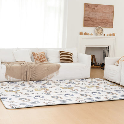 Living room with a white sofa, striped rug, and decorative items.