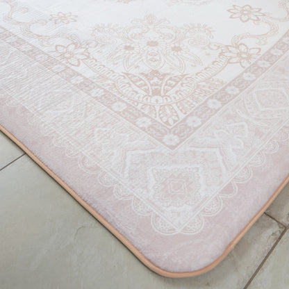 Patterned pink bath mat on a tiled floor