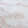 Close-up of textured fabric with floral patterns in beige on a white background