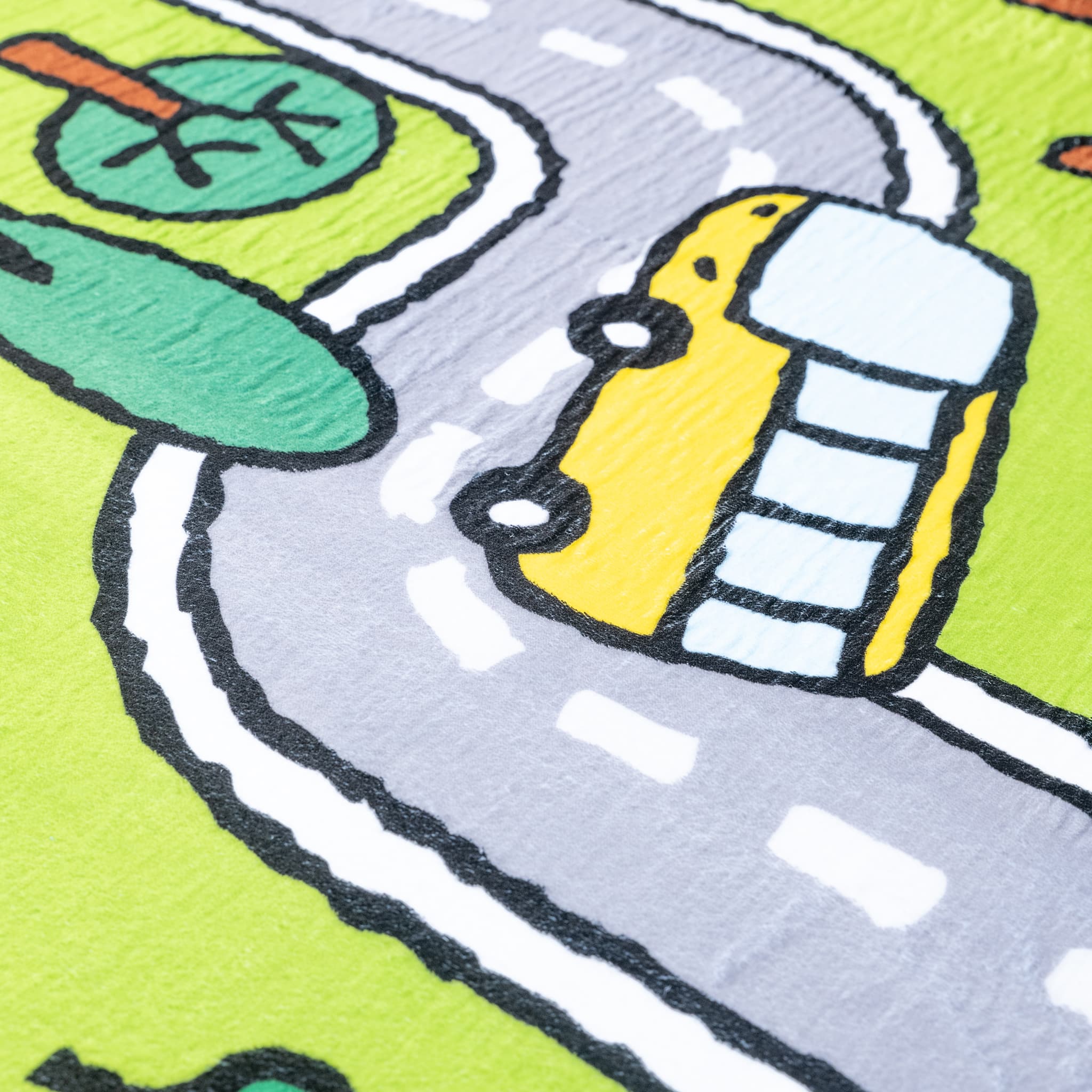Children's play mat with a cartoon car on a road