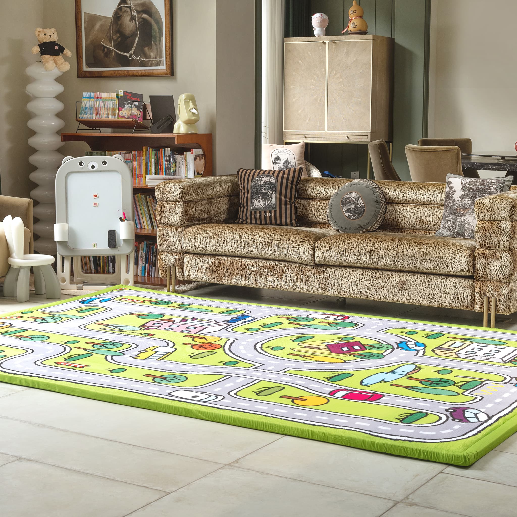 Living room with a colorful play mat on the floor, sofa, and books.