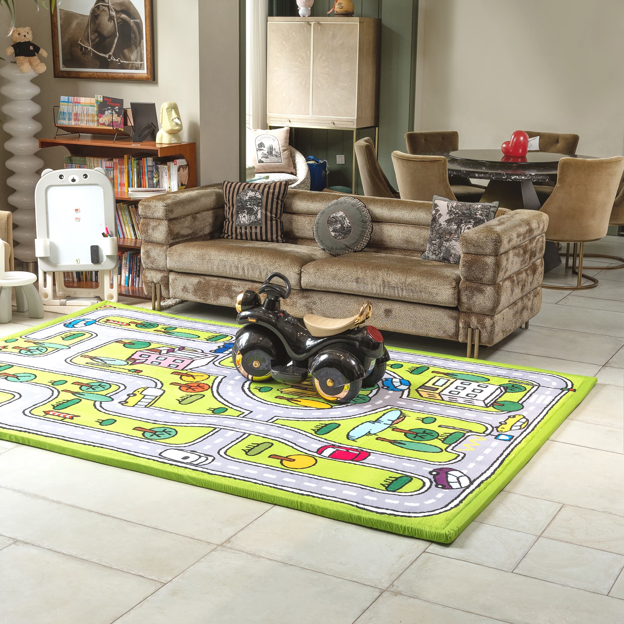 Living room with a colorful rug featuring a car design, a sofa, and a bookshelf.
