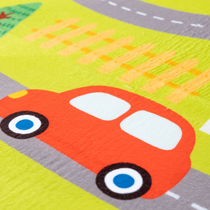 Children's play mat with a red car and road markings on a green background
