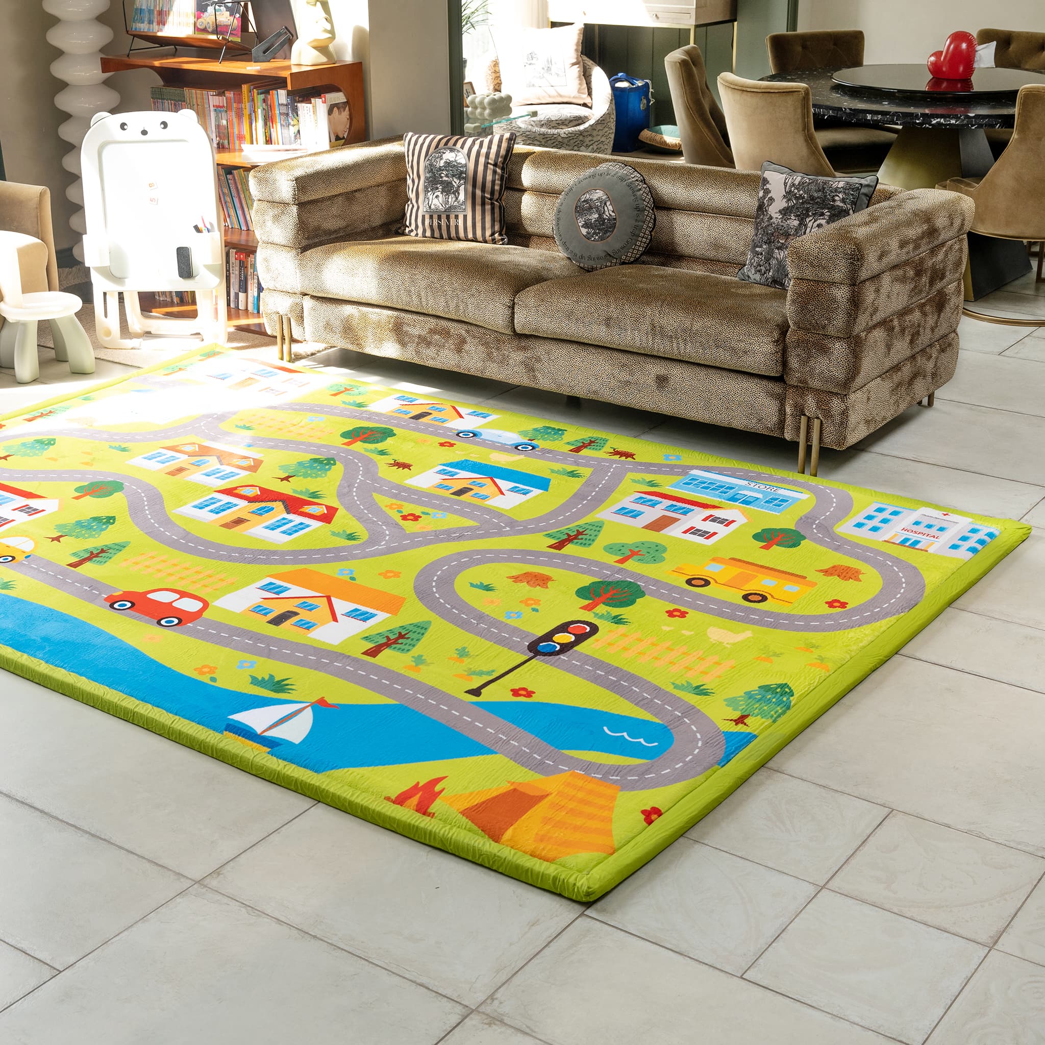 Colorful children's play rug with road and vehicle patterns on a tiled floor.