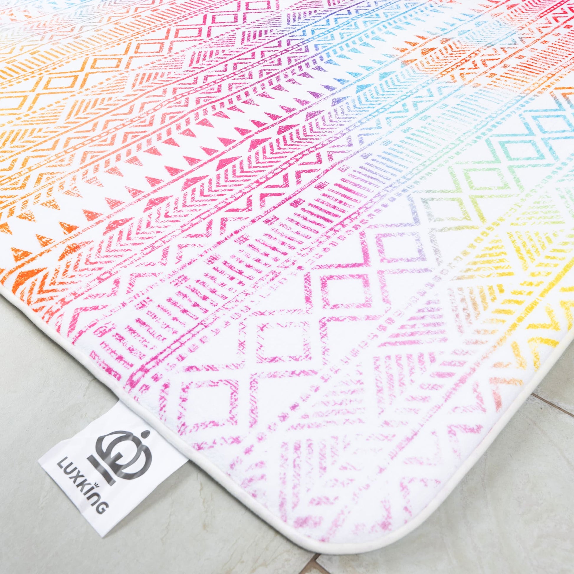 Colorful patterned rug with geometric designs on a light surface, featuring the brand 'Lukking'.
